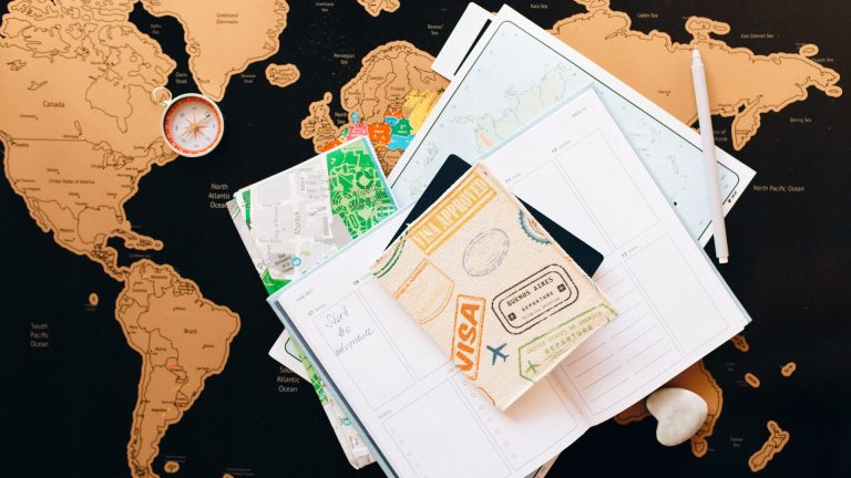 "Express Entry vs. Provincial Nominee Program (PNP) – Your Path to Canada | A travel-inspired image showcasing a world map, visa-stamped passport cover, and immigration planning documents, representing the journey to Canadian permanent residency. Discover how Express Entry and PNP can help you achieve your immigration goals and make a smooth transition to Canada."