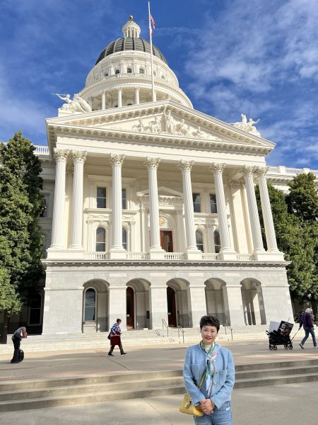 RCIC Cellia Xiao visiting the California State Capitol in Sacramento, with the iconic dome and palm trees in the background. Cellia stands in front of the Capitol building on a clear day