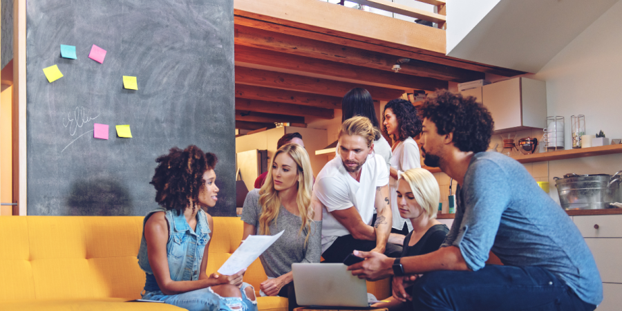 a diverse group of entrepreneurs collaborating in a modern workspace, discussing the open work permit for startup entrepreneurs and their startup plans