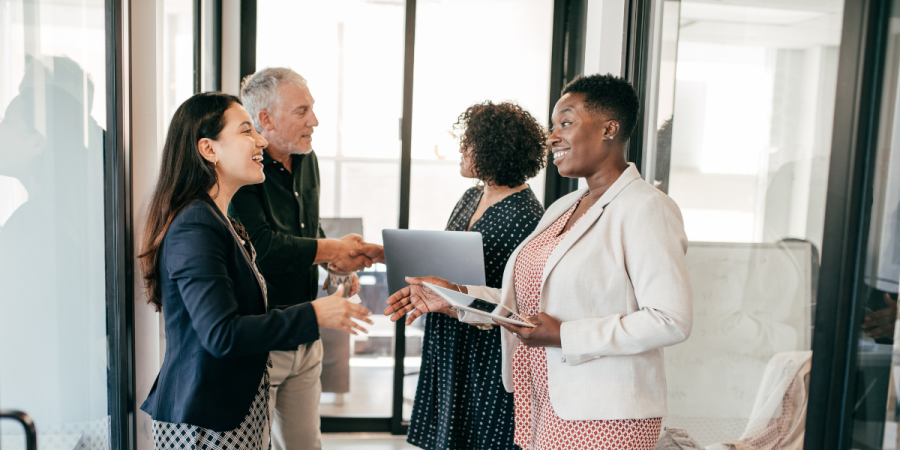 Immigration Consultant vs DIY Startup Visa: A professional business meeting where individuals are discussing immigration and startup visa processes.