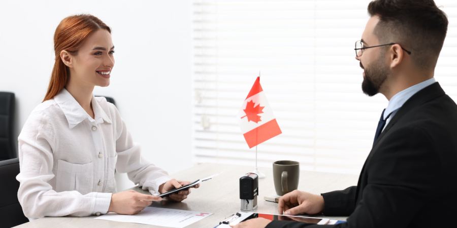 woman speaking with immigration officer during visa consultation at canadian embassy