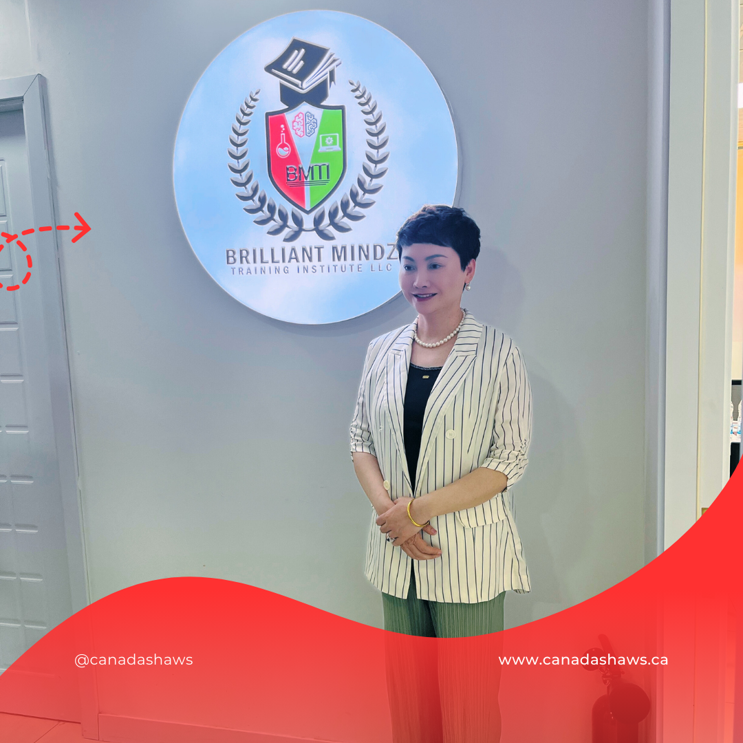 “Canada Shaws President Cellia Xiao stands in front of the Brilliant Minds Training Institute logo. She is smiling and professionally dressed in a striped blazer with a pearl necklace.”