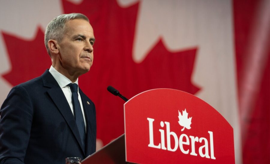 Canada Immigration 2025, Mark Carney speaking at a podium with the Liberal Party logo, backed by a Canadian flag, announcing Canada’s 2025 immigration plan. Canada Immigration Plan.