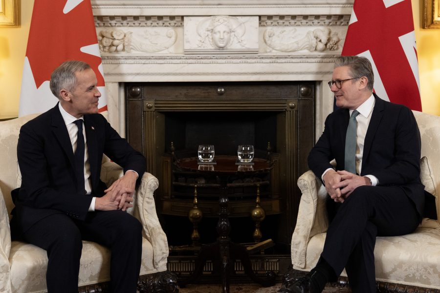 Canada Immigration Mark Carney and UK Prime Minister Keir Starmer meet in a formal diplomatic setting, seated before national flags, discussing international cooperation in 2025. Canada Immigration 2025