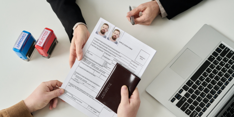 FSTP vs. PNP visa application review with passport, approval stamps, and immigration form