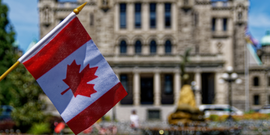 canadian flag outside government building as newcomers prepare for canada pr