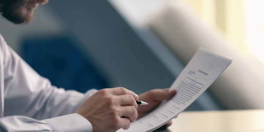 person filling forms and paperwork