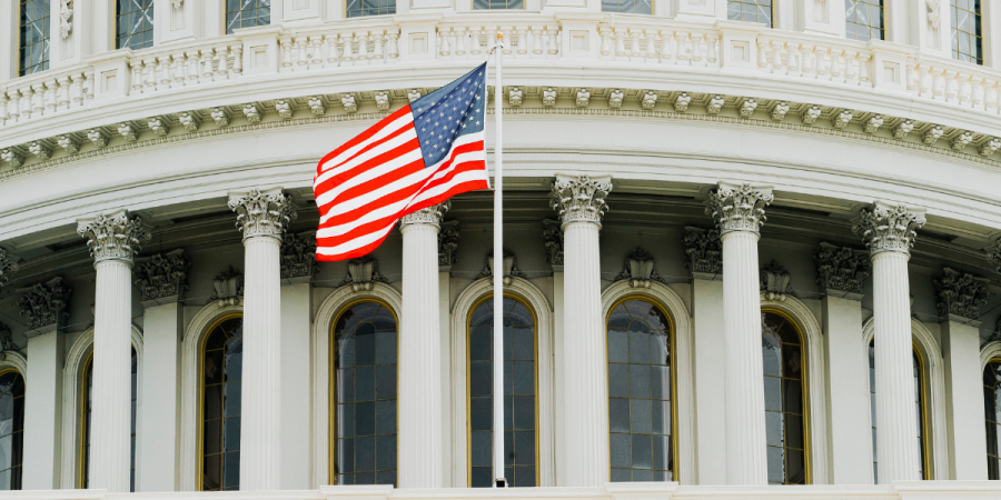 usa flag flying at capitol building