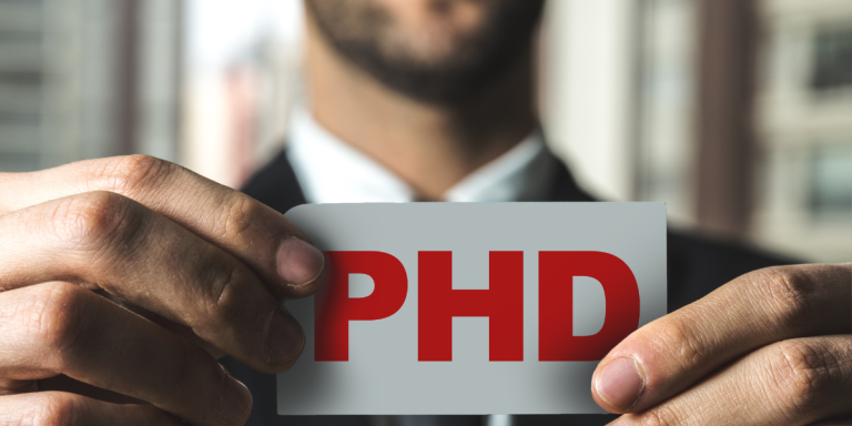 man holding phd sign representing phd scholarships opportunities