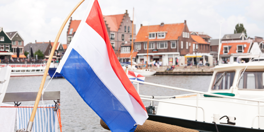 netherlands flag on boat in harbor best countries to study abroad