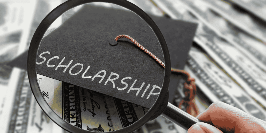 scholarships for undergraduate students​ magnifying scholarship text on money