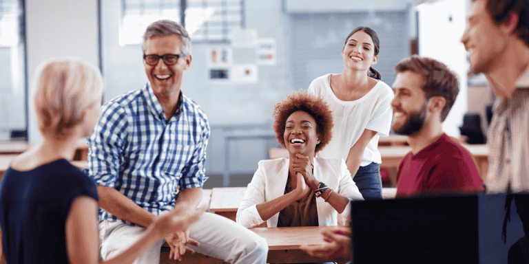 group of colleagues laughing together reflecting positive work culture