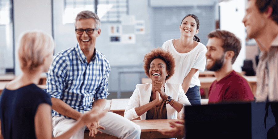 group of colleagues laughing together reflecting positive work culture