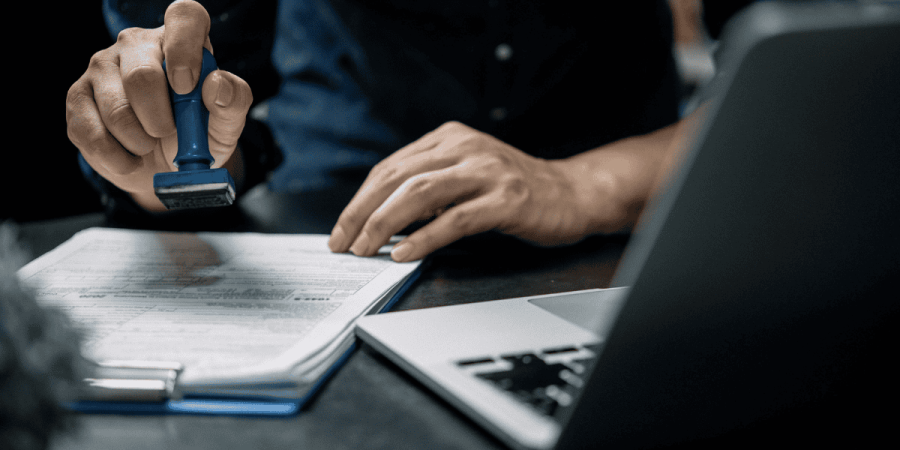 immigration officer stamping documents showing lmia delays