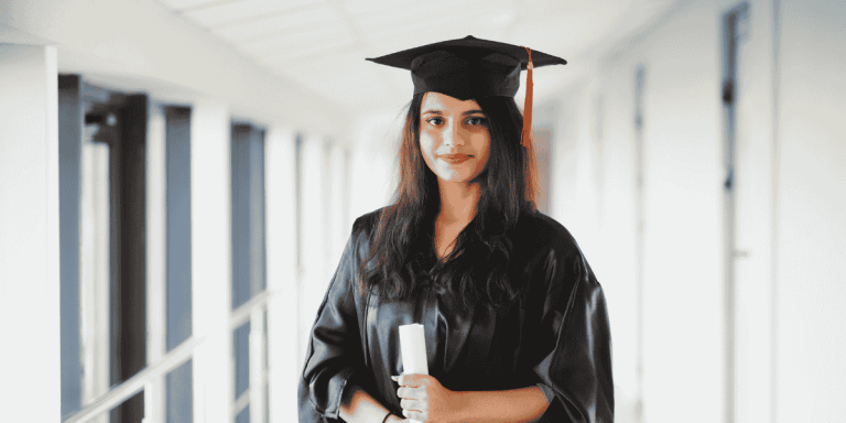 Female graduate holding a diploma, representing scholarships for Indian students