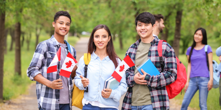 why-study-in-canada-international-students-holding-canadian-flags-on-campus