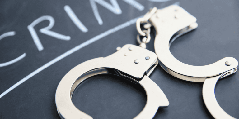 handcuffs on chalkboard representing increase in local crime rate